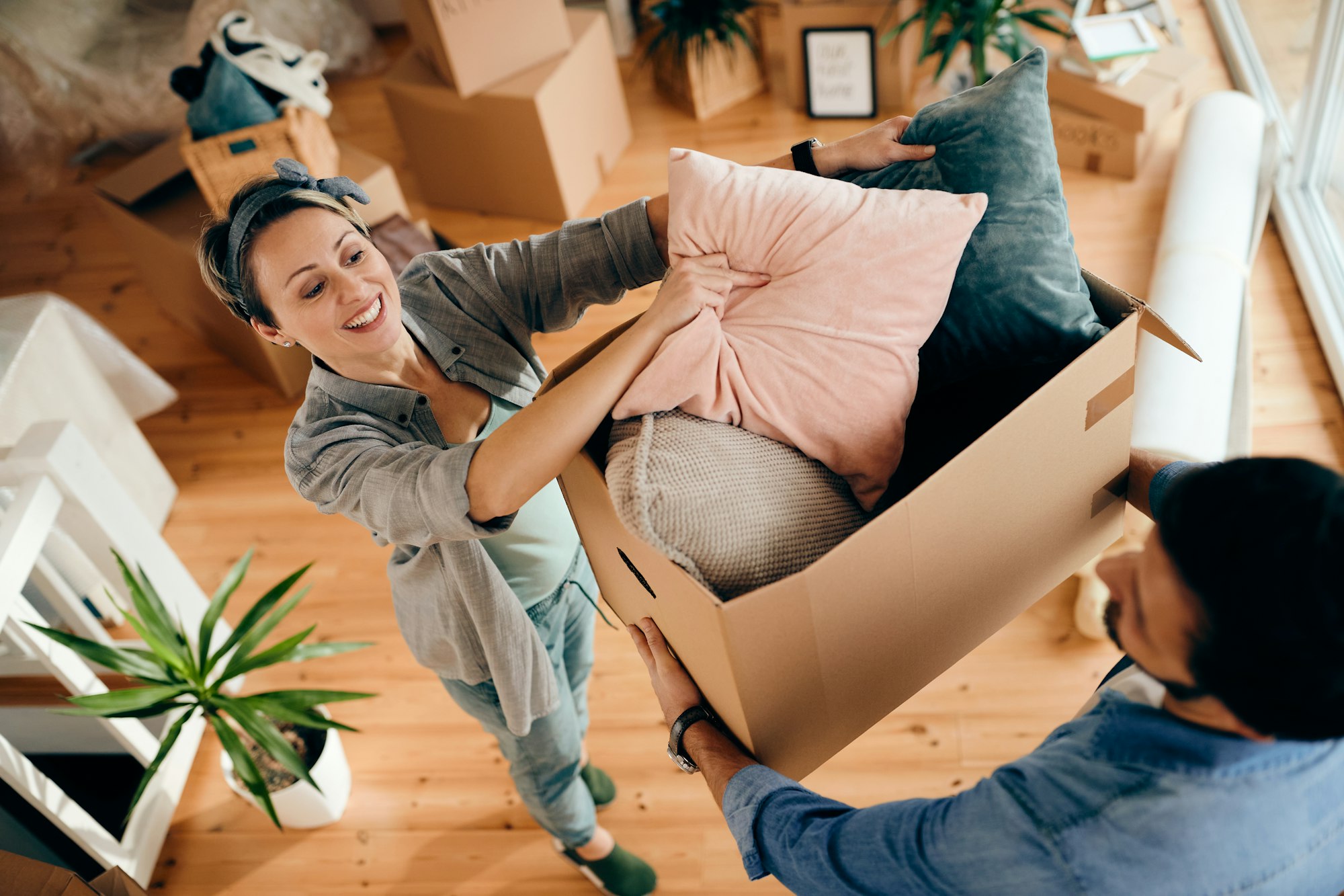 Above view of happy couple moving into their new home.